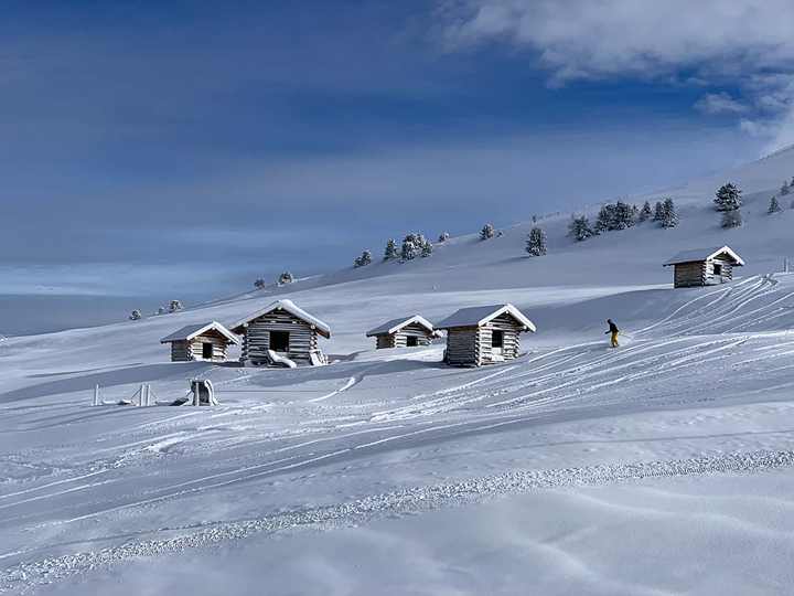 Verschneite Heustadel auf der Hochfläche mit einer frischen Skispur